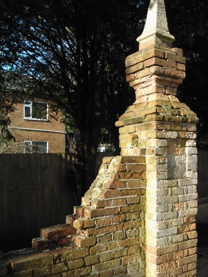 Before consolidation and repairs to Grade I listed church boundary wall